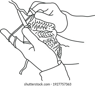 Women's hands hold knitting needles and knit. A woman knits from thick yarn. Handmade clothes. The girl sits on the couch and goes in for her hobbies. Knitting close up.