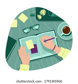 Women's hands hold a pen and write in a notebook. Top view of people working or are being trained.