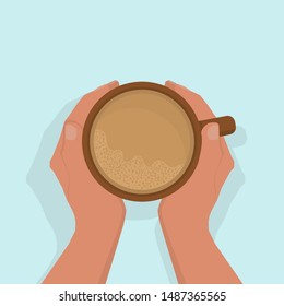 Women's hands are warming, gently holding a cup of hot cocoa, with froth. View from above. On a light blue background, with shadow. Flat style.