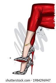 Women's legs in stylish trousers and high-heeled shoes