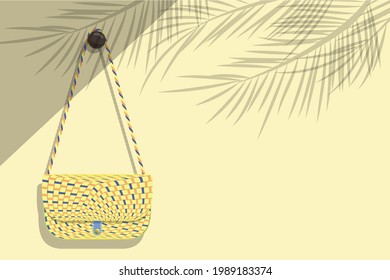 Women's Weave Pattern Shoulder Bag Was Hung On A Light Brown Wall Where Sunlight Poured Into The Room Against The Shadows Of The Coconut Leaves Concept Of Summer Travel Trip