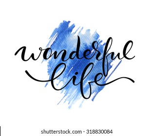 Wonderful life lettering. Hand drawn letters. Modern calligraphy. Abstract blue watercolor background.