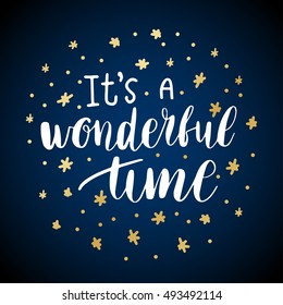 It's a wonderful time. Christmas greeting card with calligraphy. Handwritten modern brush lettering. White text and gold stars on blue background.