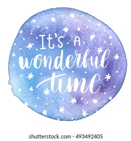 It's a wonderful time. Christmas greeting card with calligraphy. Handwritten modern brush lettering. White text on violet watercolor painted spot