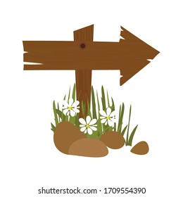 wood arrow shape pointing direction grass and flower