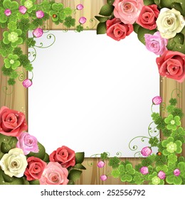 Wood background with sheet of paper, clover and roses
