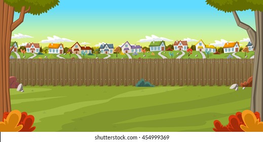 Wood fence on the backyard of a colorful house in suburb neighborhood. Green garden with grass, trees, flowers and clouds.