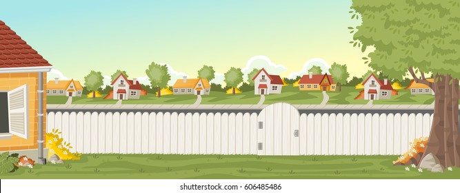 Wood fence on the backyard of a colorful house in suburb neighborhood. Green garden with grass, trees, flowers and clouds.
