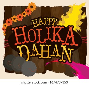 Wood logs like a sign with greeting message and traditional elements to celebrate Holika Dahan: wreath of marigold flowers, cow dungs and colorful powder for this Indian holiday.