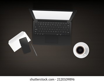 Wood table with modern laptop, smartphone, envelope and cup of coffee at night. Working place concept. 

