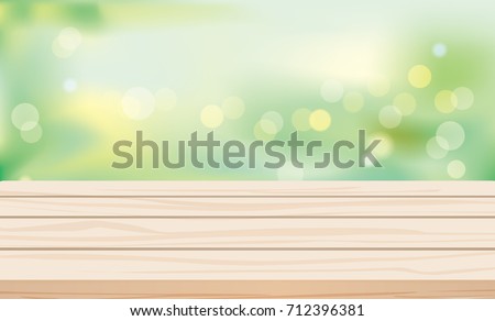 Wood table top on green blurred abstract background.