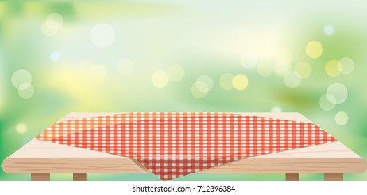 Wood table top with tablecloths on green blurred abstract background.