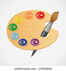 Wooden art palette with brush.