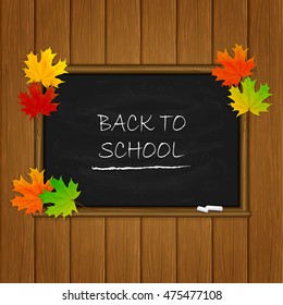 Wooden background with maple leaves and words Back to School written in white chalk on a black chalkboard, illustration.