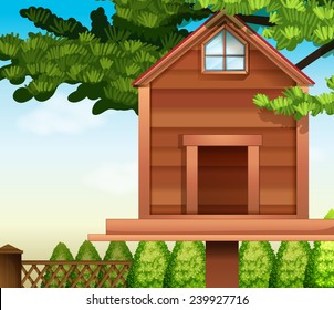 A wooden bird house and the green plants