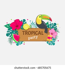 Wooden board with an inscription Tropical Party on background of tropical leaves, toucan and fruit