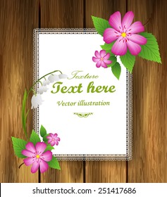 Wooden board with a sheet of paper and flowers.