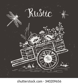 Wooden cart with wildflowers and dragonflies. Rustic style.