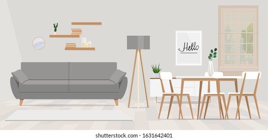 Wooden chairs at table in bright open space interior with lamp next to grey couch. 