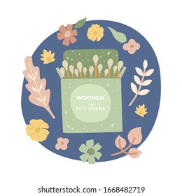 Wooden ear sticks using cotton, in a beautiful green package, on a floral background. Zero waste, organic materials. Go green, less plastic. 