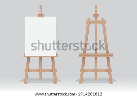 Wooden easel stand with blank canvas on white background