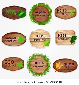 Wooden Eco labels , badges, stickers collection with green leaves and grass - Bio and natural product,  gluten free, organic product, farm fresh. Vector illustration.