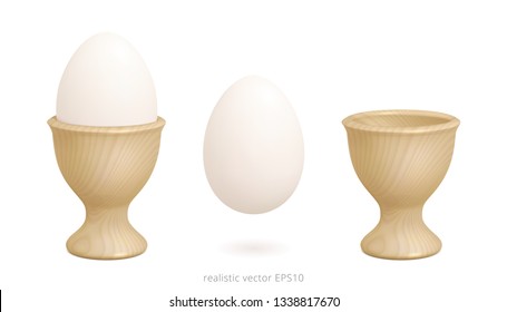 Wooden egg cups. 3d realistic vector design of holder with a gradient mesh and light yellow wood texture. Boiled chicken egg floats over white background. Sharp detailed clipart. Isolated objects