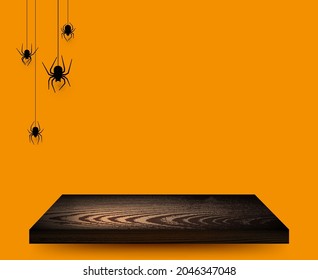 Wooden empty surface on orange background with spiders. Space for text. Vector holiday illustration.