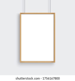 Wooden frame with poster mockup hanging on gray wall.