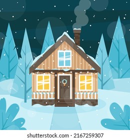A wooden house decorated for Christmas on the background of snow-covered fir trees. Winter evening. 