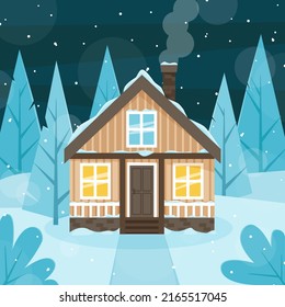 Wooden house on the background of fir trees. Snowy winter evening. 