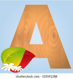 Wooden letter with autumn leaves on blue background