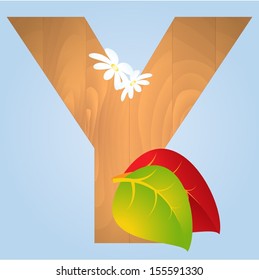 Wooden letter with autumn leaves on blue background