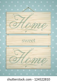 Wooden panel sign with 'home sweet home' message on blue polka dot