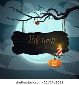 Wooden plate with the inscription: "Halloween" hanging on a branch