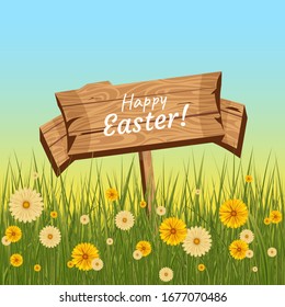 Wooden plate with the text happy easter which sticks out in the grass with flowers. 