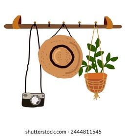 A wooden rack with a straw hat, camera, and hanging potted plant.