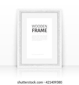 Wooden rectangle white frame on a glossy surface. Clipping paths included.