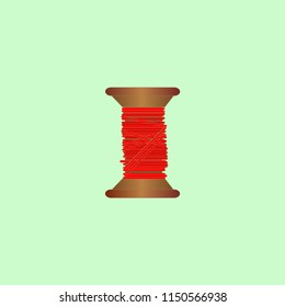 wooden reel with red thread for sewing