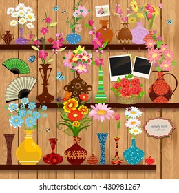 Wooden shelves with lovely flowers and photo frames for your design