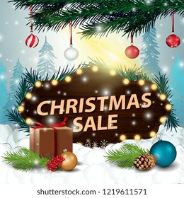 A wooden sign at a discount in the snowdrift with gifts