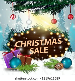 A wooden sign at a discount in the snowdrift with gifts