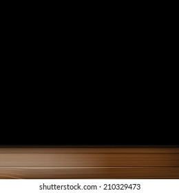 a wooden table on a black background