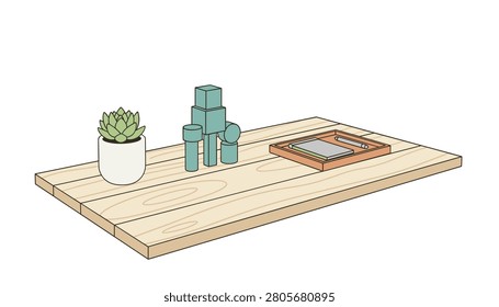 Wooden table workspace featuring a small succulent plant in a white pot, stacked blue geometric blocks, and a tray with a notebook for office or study concepts.