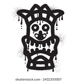 Wooden tiki mask graffiti with black spray paint art