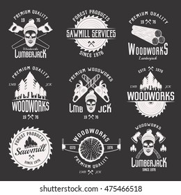 Woodworks monochrome emblems of sawmill and lumberjack services with working tools on black background isolated vector illustration