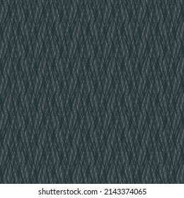 Wool or cotton fabric with a chevron or herringbone pattern. Gray blanket texture. Background detail with interwoven fibers.