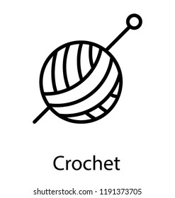 Wool on a ball having needles pinned in it symbolizing crochet