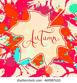 Word Autumn hand written over maple leaf on a bright orange and red artistic paint splatter background. Contemporary calligraphy. Square format Autumn card.