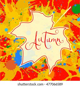 Word Autumn hand written over maple leaf on a bright orange artistic paint splatter background. Contemporary calligraphy. Square format Autumn card.